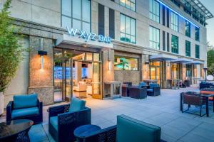 a view of a building with chairs and tables at Aloft by Marriott Cupertino in Cupertino