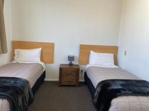 Voodi või voodid majutusasutuse George Street Motel Apartments toas