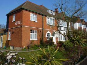 a red brick building with a hotel sign on it at Glendevon House Hotel in Bromley