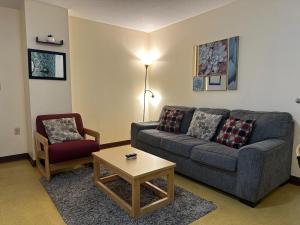 a living room with a couch and a chair at Stay Pittsburgh in Pittsburgh +84 photos