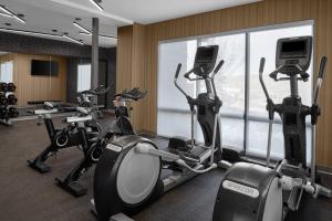 a gym with cardio machines and a large window at AC Hotel Park City in Park City