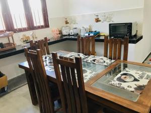 a dining room table with chairs and a glass tableasteryasteryasteryasteryasteryastery at River Beach View in Hikkaduwa