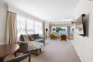 a living room with a couch and a table at Stunning Lake Views & Hospital Location in Hamilton