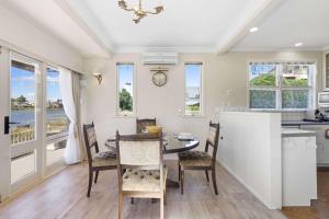 a kitchen and dining room with a table and chairs at Stunning Lake Views & Hospital Location in Hamilton