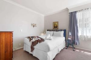 a bedroom with a large white bed and a window at Stunning Lake Views & Hospital Location in Hamilton