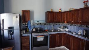 a kitchen with a refrigerator and a stove top oven at Casa QI in Santa Cruz Huatulco +10 photos