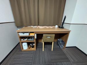 a desk with a computer on top of it at Hotel 1-2-3 Kurashiki in Kurashiki