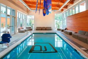 a swimming pool in a house with a room with windows at Aloft by Marriott Columbus Westerville in Westerville