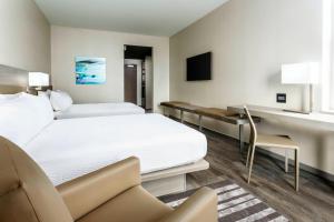 a hotel room with two beds and a desk at AC Hotel by Marriott Spartanburg in Spartanburg +37 photos