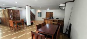 a kitchen and dining room with a table and chairs at JP Place Koh lanta in Ko Lanta