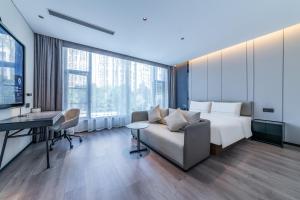 a hotel room with a bed and a desk at Atour Hotel Panzhihua East District Jinhai Century City in Panzhihua +25 photos