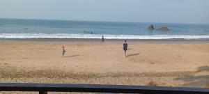a group of people playing frisbee on the beach at Nana's Nook in Agonda