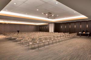 a conference room with rows of chairs and a podium at Aloft Dallas Love Field in Dallas