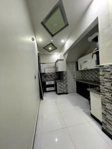 a small kitchen with a ceiling with a mirror at Nursery Guest House in Karachi +24 photos