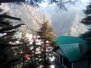 a view of the mountains from a house at Himalayan Triund Hill View Hostel in Dharamshala