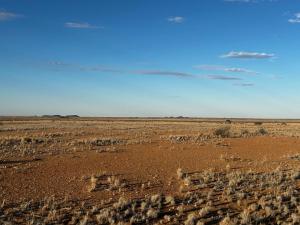 an empty desert with a blue sky in the background at Opiklip Wild Camping in Pofadder