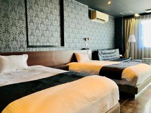 Postel nebo postele na pokoji v ubytování Hotel Square FujiGotemba