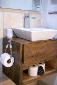 a bathroom with a sink and two rolls of toilet paper at Casa Madera 1A in Zacatlán +5 photos