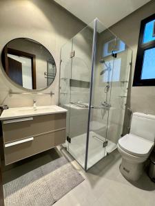a bathroom with a shower and a sink and a toilet at Dasman 50 in Kuwait +16 photos