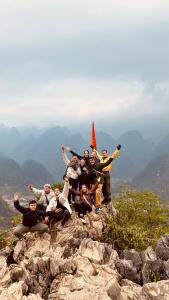 a group of people standing on top of a mountain at Cao Banh Homestay in Ha Giang
