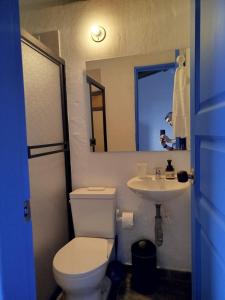 a bathroom with a white toilet and a sink at Patio Chic in Jericó