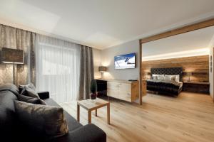 TV a/nebo společenská místnost v ubytování Alpines Gourmet Hotel Montanara