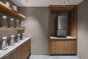 a kitchen with vases and a small appliance on a shelf at AC Hotel by Marriott Louisville Downtown in Louisville