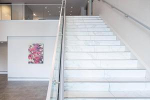 a staircase in a museum with a painting on the wall at AC Hotel by Marriott Louisville Downtown in Louisville