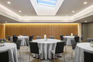 a conference room with tables and chairs and a skylight at AC Hotel by Marriott Louisville Downtown in Louisville
