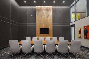 a conference room with a table and chairs at AC Hotel by Marriott Louisville Downtown in Louisville