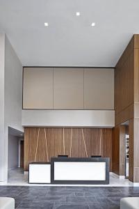 a lobby with a reception desk and wooden walls at AC Hotel by Marriott Louisville Downtown in Louisville