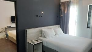 Postel nebo postele na pokoji v ubytování Manhattan Hotel Ipoh