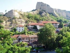 a group of houses in front of a mountain at Despot Slav Hotel & Restaurant in Melnik