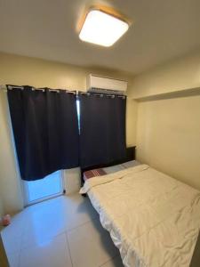 a small bedroom with a bed and a window at Breeze Residences 26th floor in Manila +18 photos