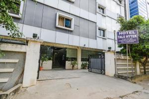 a hotel has a sign in front of a building at Hotel Tals Hitech - Nr Jubliee Enclave, Hitech CIty in Hyderabad