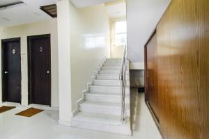 a staircase in a house with two doors at Hotel Tals Hitech - Nr Jubliee Enclave, Hitech CIty in Hyderabad