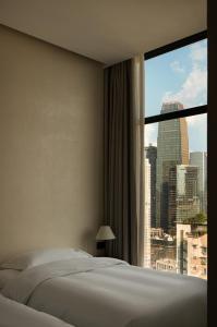 Postelja oz. postelje v sobi nastanitve Chongqing Fangwujian Garden Hotel