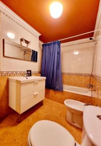 a bathroom with a toilet and a sink and a tub at Beachfront Bungalow In La Mata, Torrevieja in Torrevieja