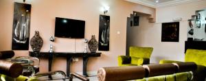 a waiting room with chairs and a tv on the wall at Auris Court - 2 Bedroom Apartment in Jabi