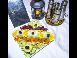 a plate of food in the shape of a face at Splendid desert Saharian Luxury Camp in quiet and idyllic sand dunes in Tisserdmine