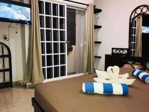 a bedroom with a bed with a large window at 5th Avenue 3 people Balcony Apartment in Playa del Carmen