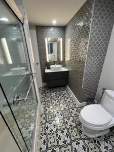 a bathroom with a toilet and a sink and a shower at Place near the Coquitlam River Park in Coquitlam +21 photos