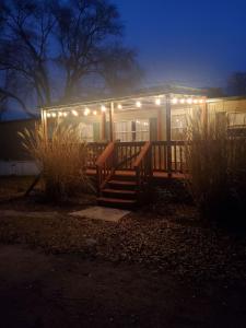 a house with lights on the front of it at night at Quiet Cozy Cottonwood Cottage in Scotia in Scotia