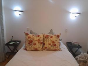 a bedroom with a bed with two lights on the wall at Quiet, Very Specious Apartment In Dainfern in Johannesburg