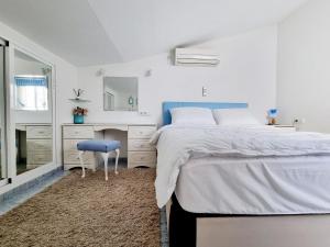 a bedroom with a bed and a desk and a mirror at Bungalow near the Salt Lakes of Torrevieja and La Mata and their beaches in La Mata +37 photos