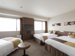 Postel nebo postele na pokoji v ubytování Hotel Keihan Kyobashi Grande
