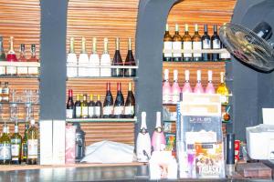 a bar with a lot of bottles of wine at Hotel Bariba Playa relaxation experience in Cotonou +16 photos