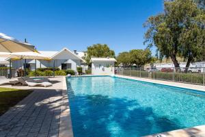a swimming pool in the backyard of a house at Cape View Beach Resort - Endless Summer in Broadwater