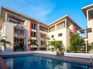 an exterior view of a building with a swimming pool at Goosepen 3 Bedrooms Apartment in Lagos