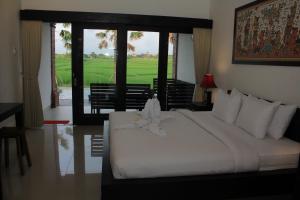 Ein Bett oder Betten in einem Zimmer der Unterkunft Kampung Canggu